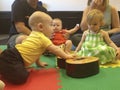 Babies in music class crawl to guitar.