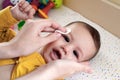 babies and newborn hygiene and healthcare. Closeup of cleaning and washing baby face with soft cottong pad Royalty Free Stock Photo