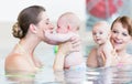 Babies and their mommies at infant swimming course