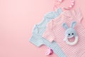 Baby accessories concept. Top view photo of pink and blue infant clothes pacifier chain and knitted bunny rattle toy on isolated Royalty Free Stock Photo