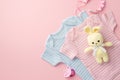 Baby accessories concept. Top view photo of pink and blue infant clothes pacifier chain and knitted bunny toy on isolated pastel Royalty Free Stock Photo