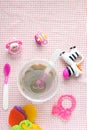 Baby accessories on pink pattern background on table Royalty Free Stock Photo