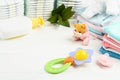 Baby accessories with shower gel or soap, pacifier, rattle, clothes and diapers Royalty Free Stock Photo