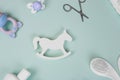 Baby accessories on tiffani background, flat lay. Composition with baby accessories and space for text. Baby cream, combs,