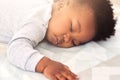 Baby, african and boy sleeping on bed for rest, health and peace for growth, development and relax in family home. Black Royalty Free Stock Photo