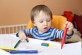 Baby age of 16 months paints with pens Royalty Free Stock Photo