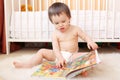 Baby age of 1 year reading book Royalty Free Stock Photo