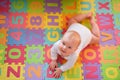 Baby on alphabet mat