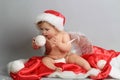 Baby angel first christmas. Beautiful little baby celebrates Christmas. New Year& x27;s holidays. Baby with santa hat with