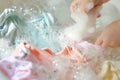 baby apparel being stirred in a crystalclear soap bath