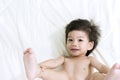 Baby Asia Posting exerciseon a bed and looking. Royalty Free Stock Photo