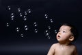 Baby asian boy looking soap bubbles. Royalty Free Stock Photo