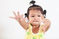 Baby asian child girl eating noodle by herself and making a mess on her face and hand Royalty Free Stock Photo