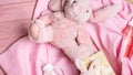 Baby baby toys background with plush bunny, baby bottle, gift box on pink background. top view, flat lay Royalty Free Stock Photo