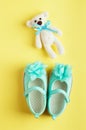 Baby background with bear toy and turquoise shoes for baby girl