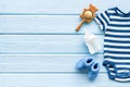 Baby background - blue color. Clothes and accessories for newborn boy on blue wooden table top-down frame copy space