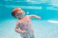 Baby background. Happy infant learn to swim, dive underwater with fun in pool to keep fit. Diving. Royalty Free Stock Photo