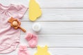 Baby background - pink color. Clothes, booties and accessories for newborn girl on white wooden table top-down frame Royalty Free Stock Photo