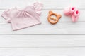 Baby background - pink color. Clothes, booties and accessories for newborn girl on white wooden table top-down frame Royalty Free Stock Photo