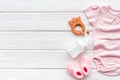 Baby background - pink color. Clothes, booties and accessories for newborn girl on white wooden table top-down frame Royalty Free Stock Photo