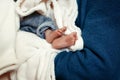 baby baptism. little feet of a boy with holy water at christening ceremony in church in godfather hands