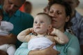 A baby baptized by mom in her arms