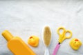 Baby bath products on white towel with copy space, child shampoo mockup,yellow duck, hair brush