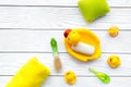 Baby bath set with yellow rubber duck. Soap, sponge, brushes, towel on white wooden background top view copyspace Royalty Free Stock Photo