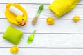 Baby bath set with yellow rubber duck. Soap, sponge, brushes, towel on white wooden background top view copyspace Royalty Free Stock Photo