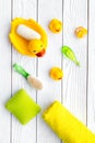 Baby bath set with yellow rubber duck. Soap, sponge, brushes, towel on white wooden background top view Royalty Free Stock Photo