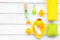 Baby bath set with yellow rubber duck. Soap, sponge, brushes, towel on white wooden background top view copyspace Royalty Free Stock Photo