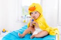 Baby in bath towel with tooth brush Royalty Free Stock Photo