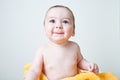 Baby After Bath Wrapped in Yellow Towel Sitting