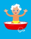 Baby bathing in a basin. Royalty Free Stock Photo