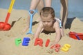 Baby on the beach with writing ferias Royalty Free Stock Photo