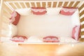 Baby bed crib with white and Burgundy color pillows with laces Royalty Free Stock Photo