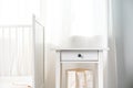 Baby bedroom interior with white wooden nightstand close up Royalty Free Stock Photo