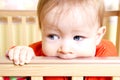 Baby In Bitting On Crib Royalty Free Stock Photo