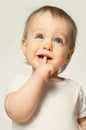 Baby blond boy check his teeth with finger Royalty Free Stock Photo