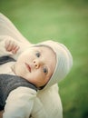 Baby with blue eyes on adorable face on hands Royalty Free Stock Photo