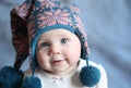 Baby with blue eyes in a winter cap Royalty Free Stock Photo