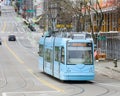 Baby blue Seattle streetcar on East Yesler Way with pantograph raised Royalty Free Stock Photo