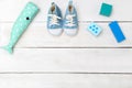 Baby blue shoes and toys on a white wooden background. View from Royalty Free Stock Photo