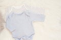 Baby Bodysuit Mockup. Styled Stock Photography. Clothes For A Boy. Jumpsuits, Rompers On A White Fur Carpet. Newborn Baby Concept