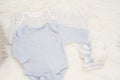 Baby Bodysuit Mockup. Styled Stock Photography. Clothes For A Boy. Jumpsuits, Rompers On A White Fur Carpet. Newborn Baby Concept