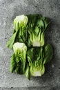 Baby bok choi halves on gray background. Top view Royalty Free Stock Photo