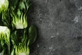 Baby bok choi halves on gray background. Top view with copy space. Horizontal image Royalty Free Stock Photo