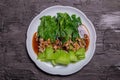 Baby Bok choy or chinese cabbage in oyster sauce with fried garlic. on black background Royalty Free Stock Photo