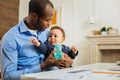 Happy father feeding his son and holding baby bottle Royalty Free Stock Photo