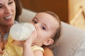 Baby, bottle and drinking milk, portrait and mom for meal, feeding and kid. Family time, eating and smile for nutrition Royalty Free Stock Photo
